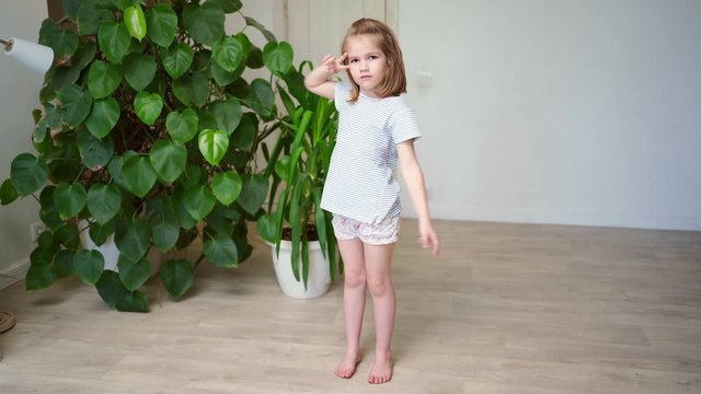 funny little girl dancing and having fun at home.