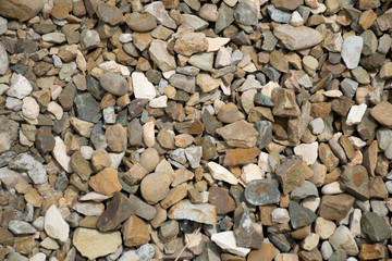 Background with stones of different colors. Stone for construction. Building material. Different textures of pebbles. Texture background.