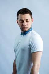 Portrait of a man in a white polo on a white background. Male image for every day. Stylish guy