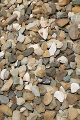 Background with stones of different colors. Stone for construction. Building material. Different textures of pebbles. Rock texture background. 