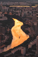 Golden Moscow river from the observation deck at sunset. Ship and city from above.