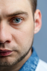 Closeup portrait of a man in a white polo on a white background. Male image for every day. Stylish guy