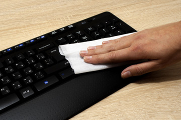 Coronavirus disinfection keyboard, mouse at office, of workspace cleaning disinfecting wipes to wipe surface of desk, Stop the spread of corona virus. hand COVID-19 