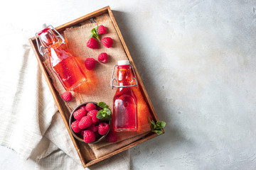 Homemade raspberry vinegar and fresh raspberries.
