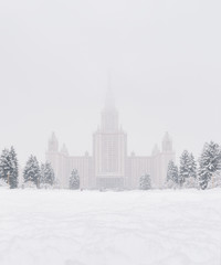 Fototapeta na wymiar Moscow State University (MSU) in the snow. Snowy city landscape.