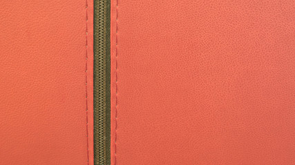 Red Leather Texture with Bronze Vertical Zipper. Macro shooting, closeup. Background