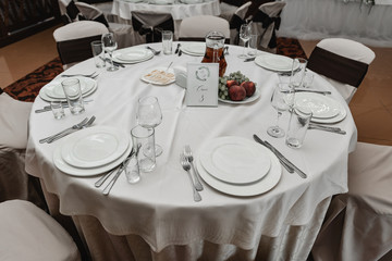 wedding decor in the banquet hall,wedding table decorated with wedding decorations,honeymoon table,arrangement of holiday dishes on the table,seating at the wedding table