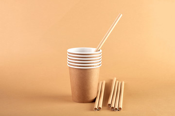 Disposable tableware made of environmental materials. Eco-friendly cookware, zero waste production from recycled materials. Paper plates, glasses, cocktail tubes. Wooden forks and knives. 