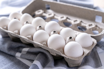 One dozen white eggs in a carton package