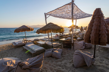 Sunset view on the Cyclades islands of Greece at a beach bar on the beach