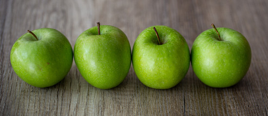 green apples on wooden background