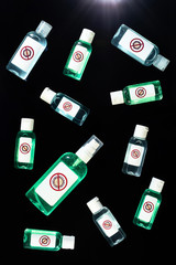 Make it clean. Top view of bottles of antiseptic hand gel isolated over black background. Hand sanitizer gel against coronavirus or Corona Virus Disease Covid-19. Personal hygiene concept