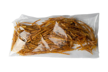 Dried salmon cobweb with pepper in a transparent package appetizer to beer isolated on white...