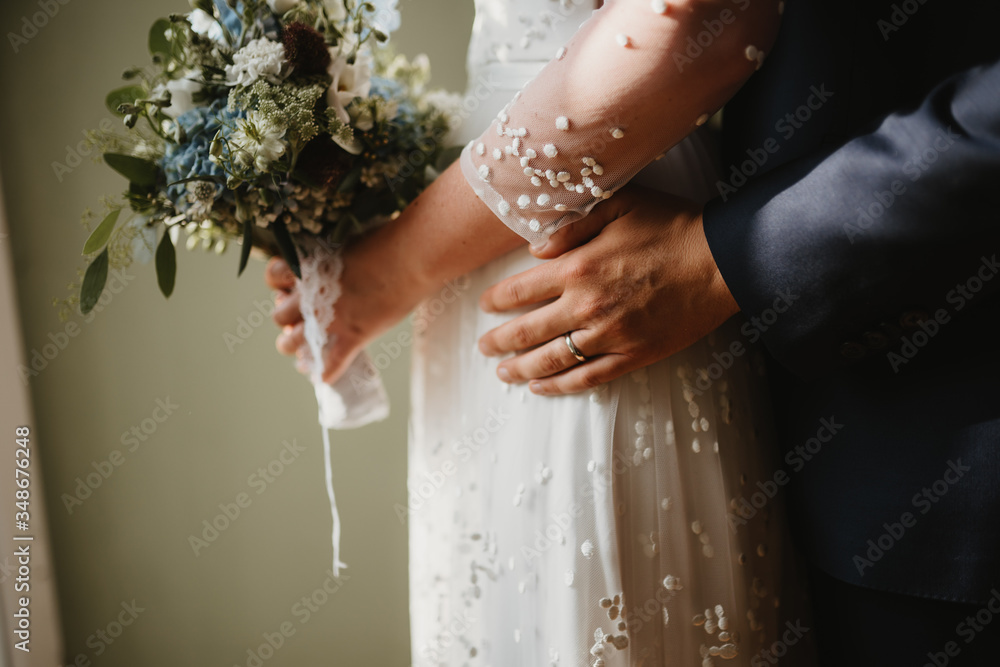 Sticker photo of a wedded couple standing next to the window