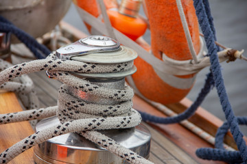 Sailboat winch and rope yacht detail. Nautical part of a yacht with cords, rigging, sail, mast,...