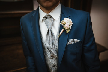 photo of a groom's suit with flowers