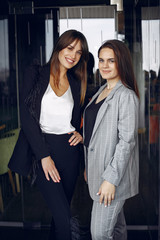 Two beautiful women working. Friends in a cafe.