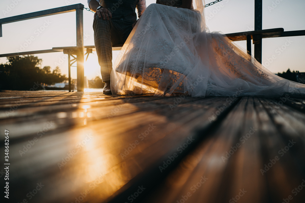 Sticker photo of a bride and a groom on a balcony at sunset