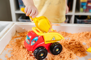 A child plays sand at home during a pandemic 