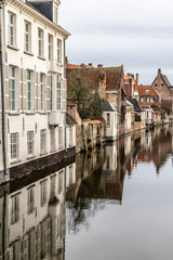 Fototapeta na wymiar Buildings around channels with reflection in Bruges