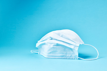 surgical protective safe mask. protection equipment over blue background. covid-19 concept.