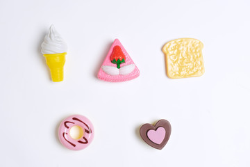 Collection of food toys for kids. Ice cream, slice of cake, donuts. Flay lay image. White background