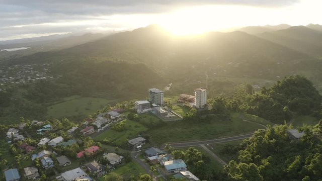 Sun setting over mountains surround pacific capital city Suva 