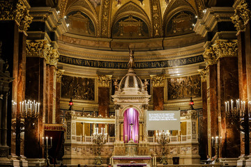 Interior of St. Stephen's Basilica with the main altar surrounded by candles.