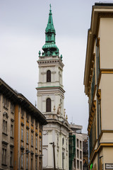 White tower with green roof typical of the streets of Budapest.