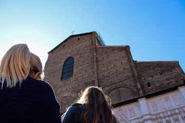 Woman looks San Petronio facade in Bologna