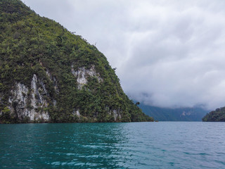 View of the Laguna Brava in Guatemala, Huehuetenango, on a cloudy day but still you can see the blue color of the water and its green mountains.