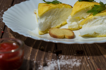 unusual omelet. egg tart. Cook at home. Gourmet breakfast in a French cafe. scrambled eggs, crackers, greens.