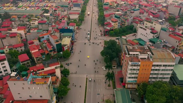 HANOI, VIETNAM - APRIL, 2020: Aerial panorama view of the roofs of houses and broadband road of the city of Hanoi.