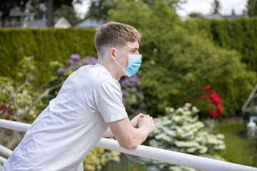 Young man outside wearing surgical mask during Covid 19