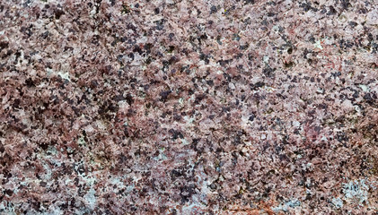 The structure of natural multi-colored stone close-up