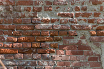 Old brick wall with cement traces and chips. brick texture, background