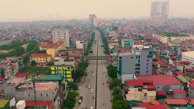 HANOI, VIETNAM - APRIL, 2020: Aerial panorama view of the roofs of houses and broadband road of the city of Hanoi.