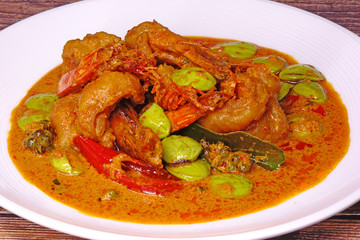 Stir fried shrimp in red curry with bitter beans, one of most famous Thai food in Southern Thailand. Close up with Selective focus.