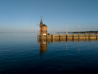 Lighthouse on an old pier, in the harbour of Konstanz (Constance City), Germany, at sunset