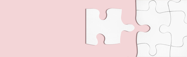 Matching puzzle piece on pink background. Business teamwork, partnership concept.