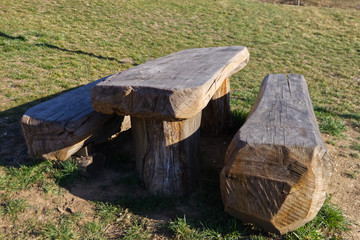 benches and table made from a single wooden trunk in a cottage