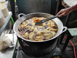 Tempeh fried in a frying pan. Tempe Goreng is traditional food from Indonesia