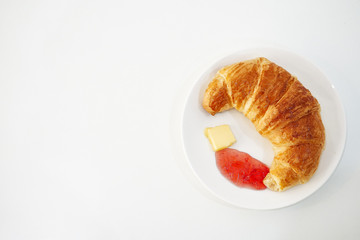 croissant with jam on withe desk.