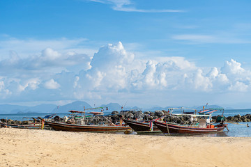 Thai traditional wooden longtail boat and beautiful sand Railay Beach in Krabi province. Ao Nang,...