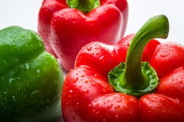 Red and green bell pepper with water drops
