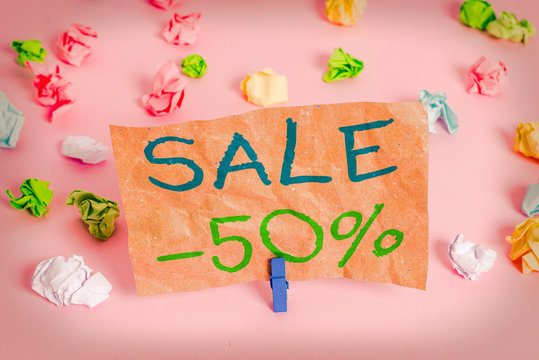 Conceptual hand writing showing Sale 50 Percent. Concept meaning A promo price of an item at 50 percent markdown Colored crumpled papers empty reminder pink floor clothespin
