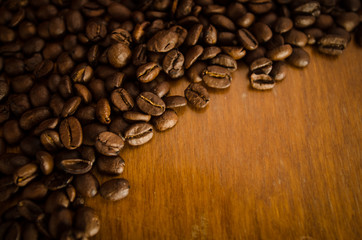 Golden coffee beans on a wood table