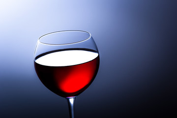 Glass of red italian wine on blue gradient