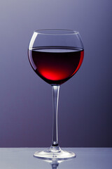 Glass of red italian wine on blue gradient