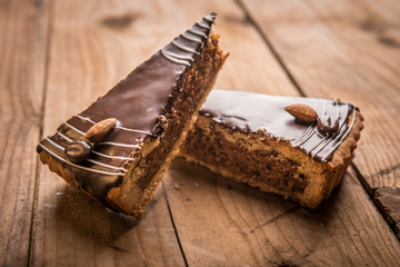 Chocolate cheese cake with nuts on a wood table